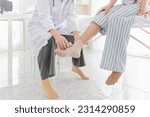 Small photo of doctor use elastic bandage treatment patient in emergency room, ankle sprain patient