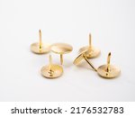 Small photo of Set of golden thumbtacks. Golden buttons.
