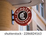 Small photo of Arlington, VA - April 2, 2023 : Chipotle Mexican Grill circular round sign on popular street in Virginia.