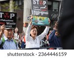 Small photo of New York, NY - Sept. 17, 2023: Angry Asian protesters march while holding signs to stop the release of Fukushima radioactive waste water into the ocean