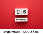Wooden calendar 2022 with inscription 25 november on red background. Black friday. Top view