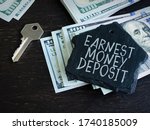 Small photo of Earnest Money Deposit label and stack of money.