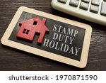 Stamp duty land tax holiday and model of house.