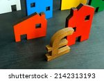 Small photo of House models and British pound sign. BTL or buy to let mortgage.