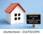 Fixed rate vs variable rate mortgage. Model of the house and a sign next to it.