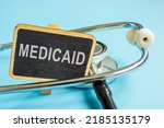 Small photo of Plate with word Medicaid and a stethoscope.