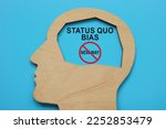 Small photo of Head figure and inscription inside Status quo bias.