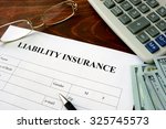 Liability insurance  form and dollars on the table.