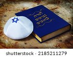 Small photo of Tanakh - Hebrew Bible and Kippah with Jewish star, Jewish symbols. Concept - Jewish religion, Jews and Judaism. The title of the book means in Hebrew - Torah, Nevi'im, Ketuvim or abbreviation Tanakh