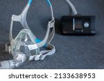 Small photo of CPAP mask with a full face mask cpap machine against obstructive sleep apnea helps patients as respirator mask and headgear clip for breathing medication in snoring sleep disorder to breath easier