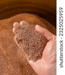 Small photo of Right hand holding recycled copper granules recovered from scrap cable. High quality photo