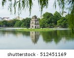Hoan Kiem lake (Sword lake, Ho Guom) in Hanoi, Vietnam with willow branches on foreground