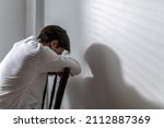 Small photo of Male depression. Upset Asian young man got problem sitting alone at home, a lot of thoughts, break up with a lover or financial difficulties and debt Overthinking Unhappy unsatisfied and trouble idea.
