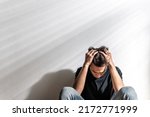 Small photo of Male depression. Upset Asian young man having problems over white background, having heavy thoughts, break up with lover or financial difficulties Overthinking Unhappy unsatisfied and trouble concept.