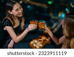 Asian woman friends celebrating dinner party together at skyscraper rooftop restaurant bar in the city at summer night. Attractive girl enjoy urban outdoor lifestyle nightlife on holiday vacation.