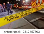 Small photo of Los Angeles California - June 3 2023 - LAPD Los Angeles Police Department Crime Scene Tape with officers and ambulance