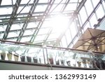 Glass ceiling with sun rays in shopping center