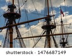 Small photo of Voronezh, Russia, June 11, 2019: View of masts of ship of Goto of Predestination moored on Admiralteyskaya Square. Close-up of foremast, mainmast and mizzen mast without sails.