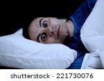 Small photo of Portrait of an insomniac man trying to sleep in his bed