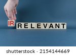 Small photo of Irrelevant or relevant. Cubes form the words Irrelevant or relevant. Concept of information and business