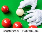 Snooker referee is replacing the cue-ball with the ball marker