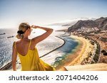 Small photo of Amazing place to visit. Woman looking at the landscape of Las Teresitas beach and San Andres village, Tenerife, Canary Islands, Spain. Tourism. Vacation. Travel.