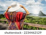 Back view of solo traveler woman enjoying Phang Nga bay view point, relaxing. Tourist at Samet Nang She, Thailand. Asia travel, trip and summer vacation concept.