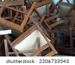 Title: Recycling dump with trash of broken chairs, wooden chairs. pile of chairs.