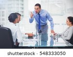 Angry executive pointing out his employee in bright office