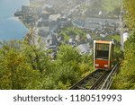 View of a Hallstatt cable car from the top station leading to a skywalk view in Austria with mist in the background.