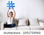 Smiling woman holding a hashtag sign social media concept