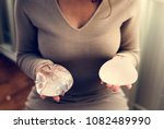 Woman holding silicon bags for breast implant