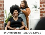 Hairstylist giving a haircut to a customer at a beauty salon