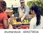 Greengrocer selling organic fresh agricultural product at farmer market