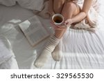 Beauty Portrait Relaxed Woman in the Morning   and Drinks Coffee in Bed. Attractive Woman Reading  Book and  Bed . Caucasian young woman   Relaxed  in Bed and Reads a Book            