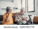 Small photo of Mature woman, wife calling emergency, talking on phone, holding old husband hand, grey haired man having heart attack, touching chest, suffering from heartache disease at home, feeling pain