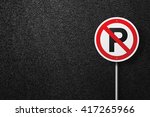 Road sign of the circular shape on a background of asphalt. No parking. The texture of the tarmac, top view.