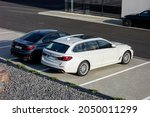 Small photo of OSTRAVA, CZECH REPUBLIC - MAY 31, 2021: The modern white BMW 530d touring vehicle and other BMWs at the dealership ready for test drive