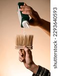 Small photo of male hand holds talcum brush and accurate pours talcum powder from a bottle on it. Barber shop tools
