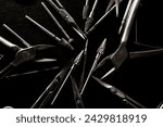 Small photo of Manicure set of tools made of steel isolated mixed on black background, scissors, cutter nozzles and nail nippers