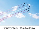 Squadron of planes fly with color trail lines of Poland Singapore Peru Monaco Malta Latvia Indonesia Denmark Austria over clouds and clear sky