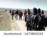 Small photo of Abstract, blurry, out of focus image for media and internetа. A group of unorganized people are trying to illegally cross the border.