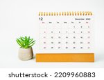 December 2022 Monthly desk calendar for 2022 year with plant pot isolated on white background.
