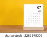 July 2023 Monthly calendar for 2023 year on yellow table.