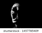 black and white photo on a black background, distorted face screaming