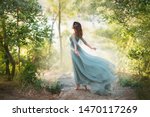 fairy-tale princess in light summer blue turquoise dress on wide path and walks towards wind, graceful dancing girl in image of flower with flying long hem of dress, nymph of bright green forest