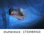 art photo sleeping beauty. blond woman lying in vintage white bed. girl sleep eyes closed sweet dream lullaby music. Shiny stars in dark retro room. princess in nightgown. Mystical miracle Night magic