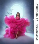 Small photo of photo with noise. Happy fantasy princess in pink ball gown. Queen woman smiling face. Carnival evening puffy lush long neon bright fuchsia color dress. Royal blue room, magical sun light from window