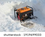 Small photo of Usage of gasoline portable outdoor generator, home power generator to backup the house during blackouts, outages as a result of a winter storm.