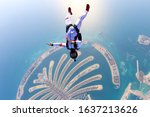 Small photo of Dubai sky conquer. Skydiver conquers the world. Skydiving team use professional equipment. Extreme sport for young men.